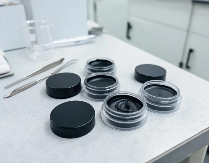 gel eyeliner pot on a cosmetics bench, illustration only